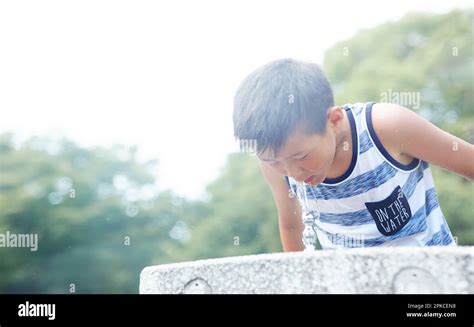 Boy drinking water at water fountain Stock Photo - Alamy