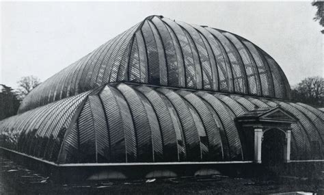 an old black and white photo of a building with a large glass dome on top