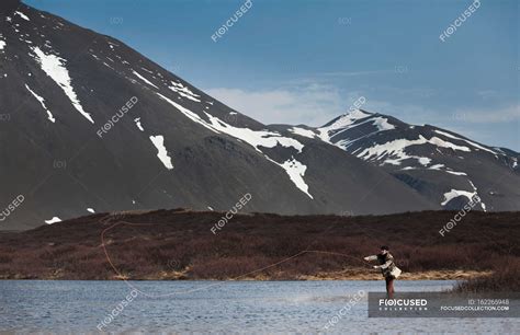 Man fishing in still lake — nature, adventure - Stock Photo | #162265948