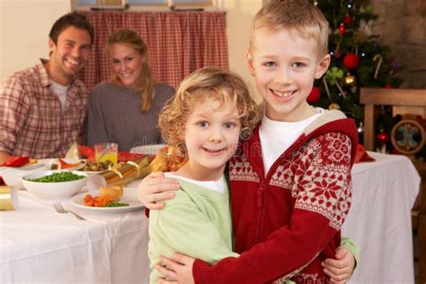 Young Family At Christmas Dinner Table Stock Photo - Image: 20463460