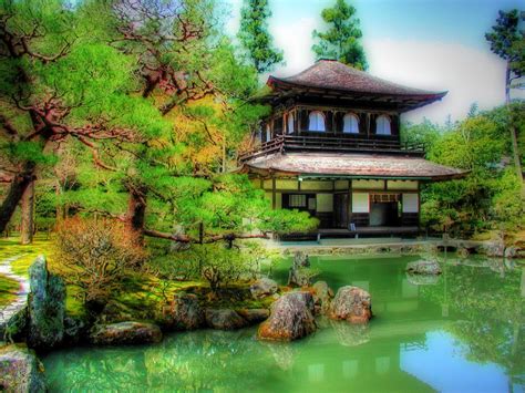 an artistic photo of a house in the middle of a pond with trees around it