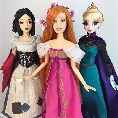 three dolls are standing next to each other wearing dresses and tiaras ...