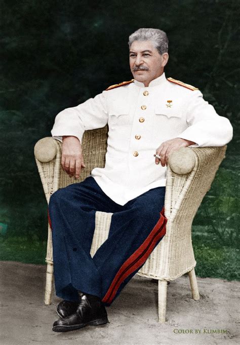 an old man in uniform sitting on a chair