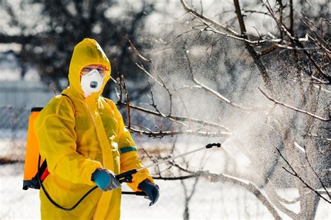 Premium Photo | Spraying a fruit tree with an organic pesticide or ...