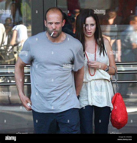 Jason Statham and his girlfriend leave a movie theatre after watching ...