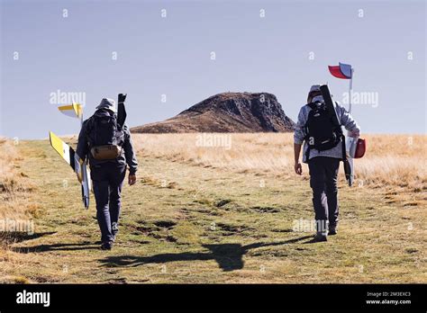 Men climb to the top of hill to launch a radio-controlled glider model ...