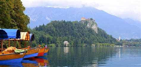 Pletna Boats on Lake Bled Photograph by Clyn Robinson | Fine Art America