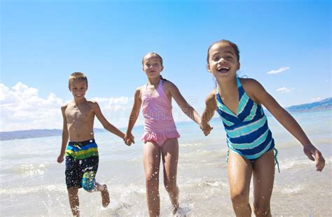 Kids playing at the Beach stock photo. Image of beauty - 25972818