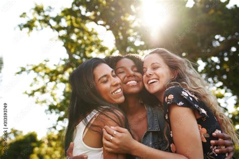 Portrait of a happy multiethnic group female friends hugging and ...