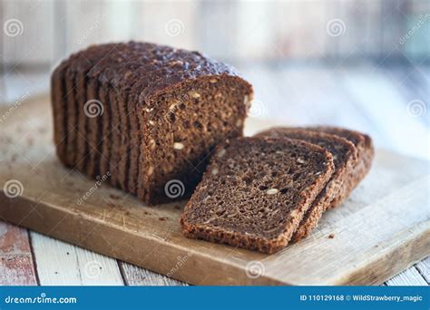 Whole-wheat Bread with Seeds Cut on a Wooden Board on a Natural Stock ...