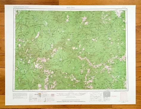 a large green map on top of a wooden floor