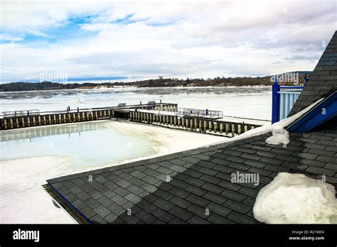 A dock and lake iced over in the winter Stock Photo - Alamy