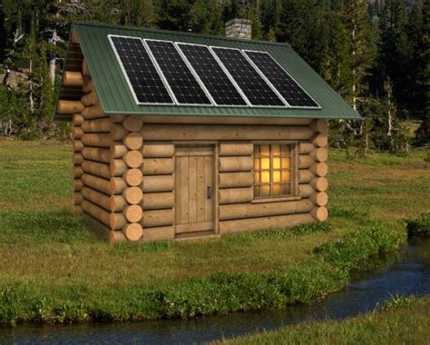 a small log cabin with solar panels on the roof and windows is lit up ...