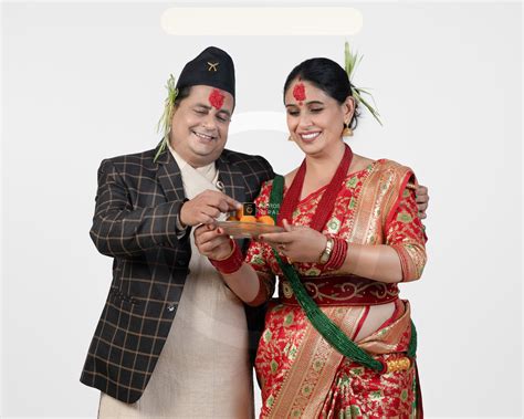 Dashain couple with laddu in red tika & jamara - Photos Nepal