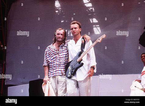 Phil Collins and Sting stand on the stage at Live Aid Charity concert ...