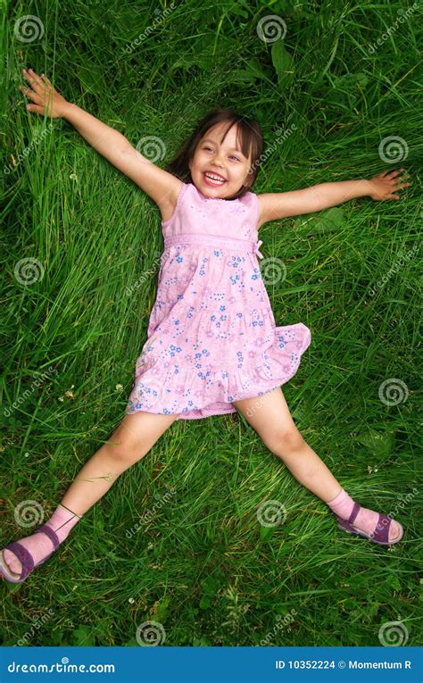 Little girl lying on grass stock photo. Image of infant - 10352224