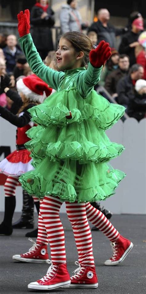 Parade participants wear festive holiday costumes. | Christmas tree ...