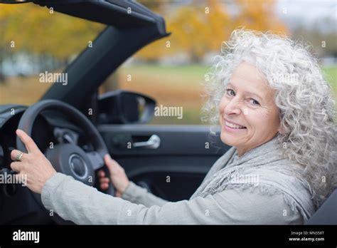 Portrait smiling senior woman driving convertible Stock Photo - Alamy