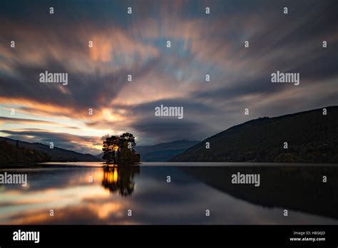 Loch Tay, Perthshire, Scotland, reflects the light from the setting sun ...