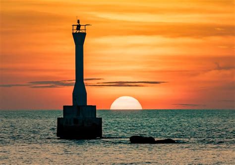 Premium Photo | Silhouette of lighthouse at sunset