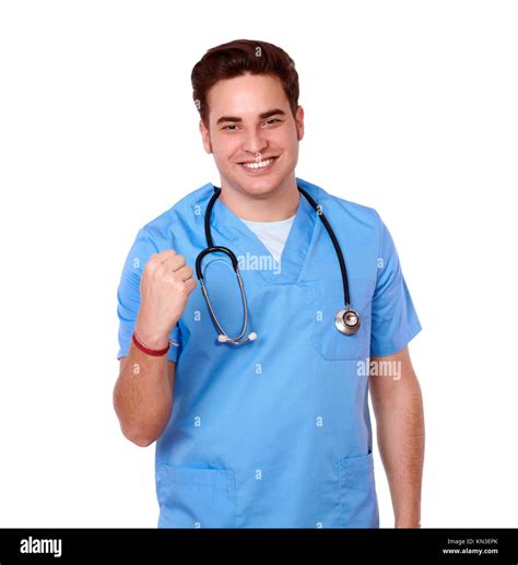 Portrait of an adult male nurse on blue medical uniform celebrating his ...