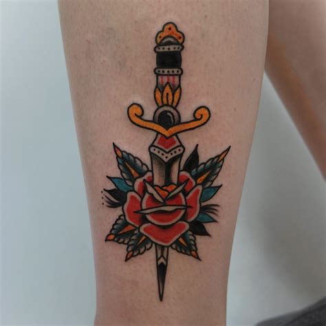 Rose stabbed with a dagger tattoo - Tattoogrid.net