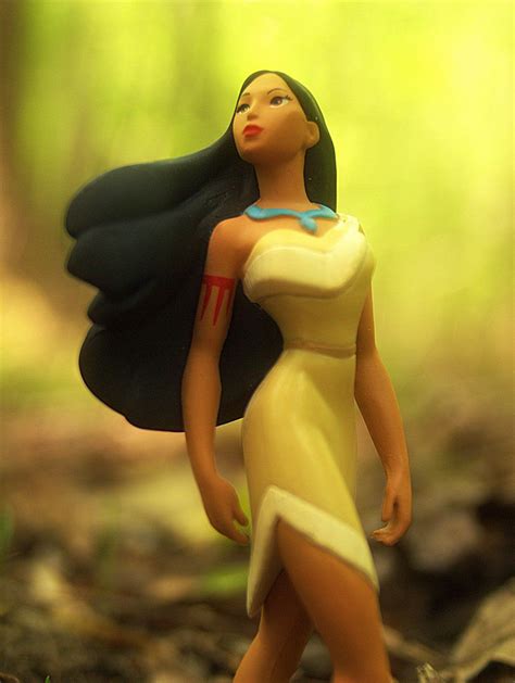 a figurine is standing in the woods with her hair blowing back and eyes ...