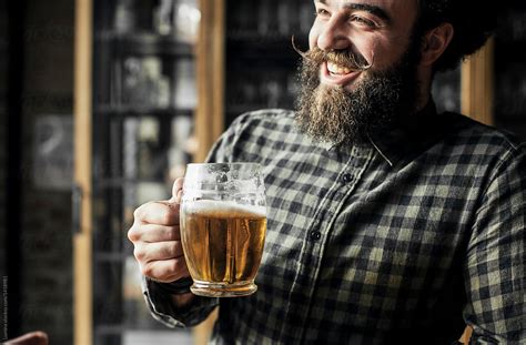 "Man Drinking Beer At Smiling Bar" by Stocksy Contributor "Lumina ...