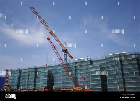 Construction cranes at building site Stock Photo - Alamy