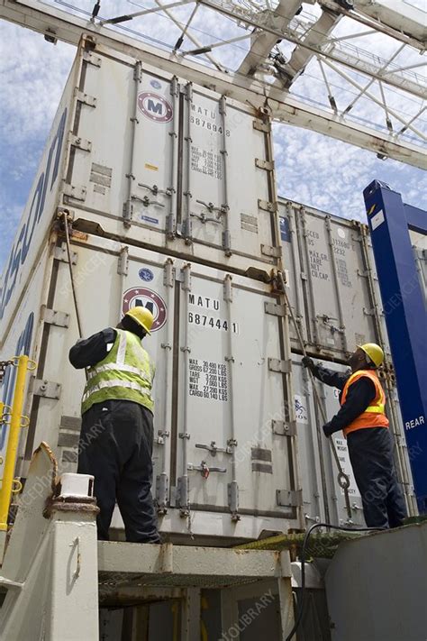 Port workers handling cargo containers - Stock Image - C020/8690 ...