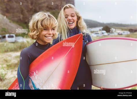 Spain, Aviles, portrait of two happy young surfers on the beach Stock ...