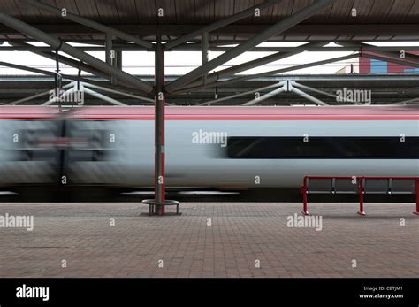 Virgin Pendolino train passing through Rugby railway station at high ...