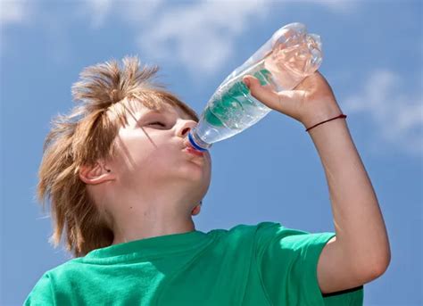 Thirsty boy drinking fresh water outdoors | Stock Images Page | Everypixel