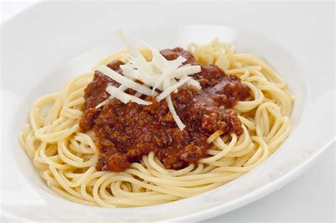 Bowl of spaghetti bolognese with parmesan cheese, close up stock photo