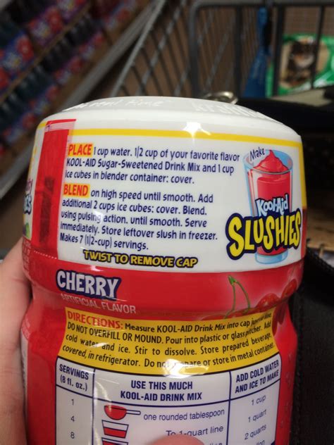 a hand holding a jar of yogurt slushies in a grocery store