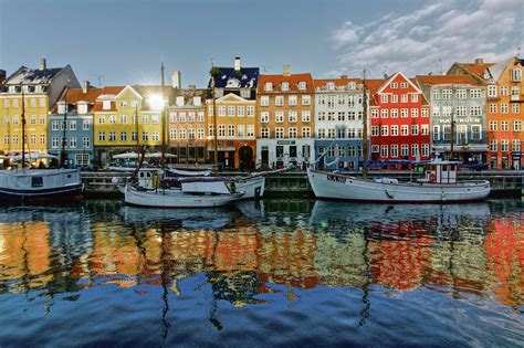 several boats are docked in the water next to some colorful buildings ...