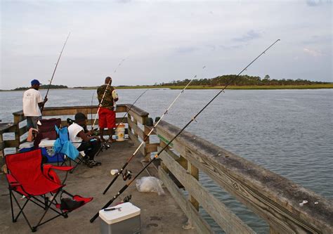 Fisherman fishing off the back river fishing pier on Tybee Island ...