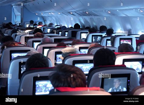 Interior of airplane during night flight Stock Photo - Alamy