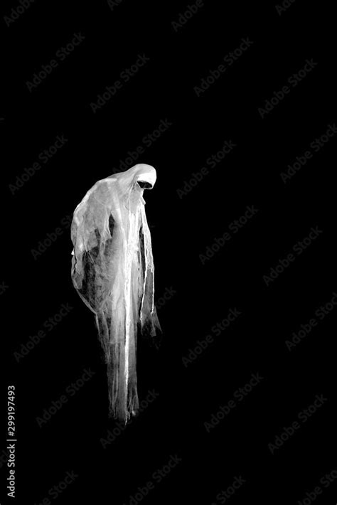 Scary ghost isolated on black background. Stock Photo | Adobe Stock