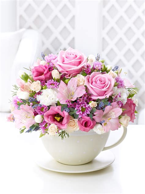 Pastel Teacup and Saucer Arrangement - Interflora | Flower arrangements ...