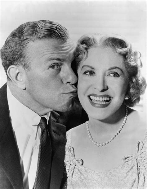 an old black and white photo of a man kissing a woman's forehead with ...