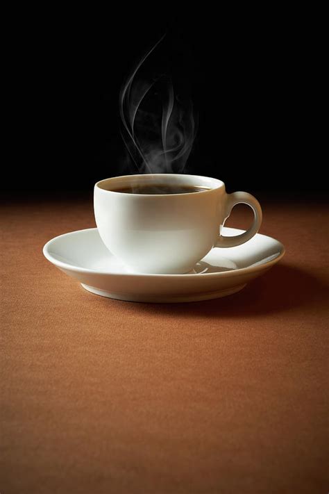 White Cup Of Coffee Sends Up Steam by Hdere