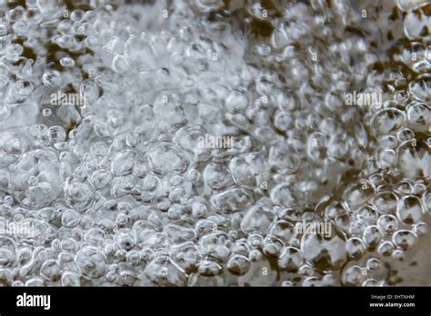 Streaming water with bubbles Stock Photo - Alamy