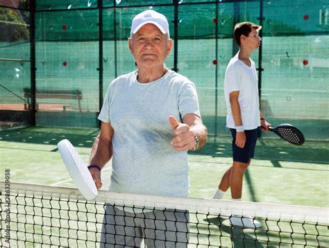 padel players of different generations posing on padel court Stock ...