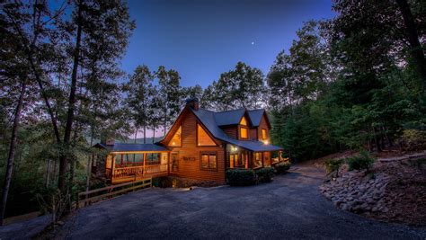 A cozy cabin in Blue Ridge, Georgia, glows warmly among trees and ...