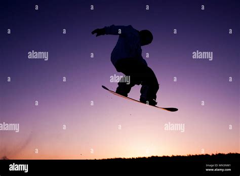 Silhouette snowboarder flying at sunset sky background. Soft focus ...