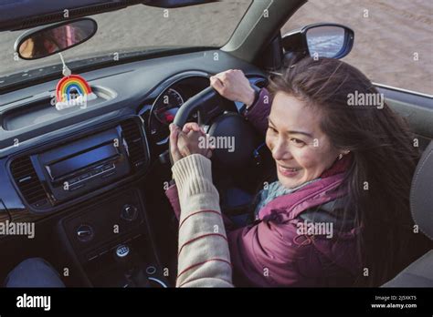 Happy woman driving convertible Stock Photo - Alamy