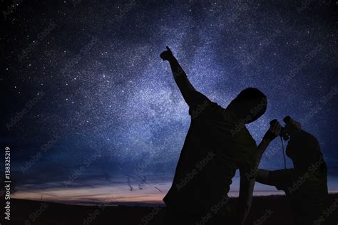 Silhouettes of people observing stars in night sky. Astronomy concept ...