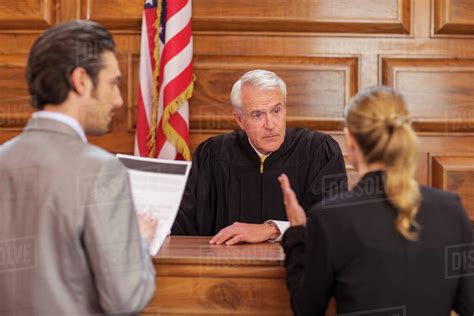 Lawyers pleading case to judge in court - Stock Photo - Dissolve