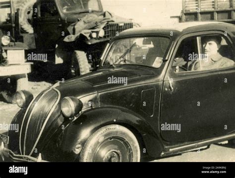 Man inside a Fiat Topolino, Italy Stock Photo - Alamy